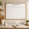 Weekly family planner printable shown in a minimalist kitchen mockup with a light wood frame, neutral decor, soft natural light, wooden utensils, a mug and a notebook on a marble countertop.